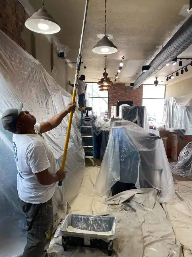 Professional painters working efficiently in an apartment unit