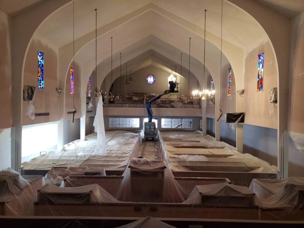 Painters working on a church interior
