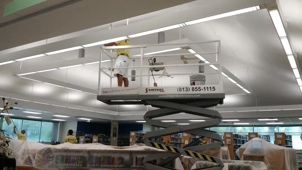 Professional painters working in a commercial office space