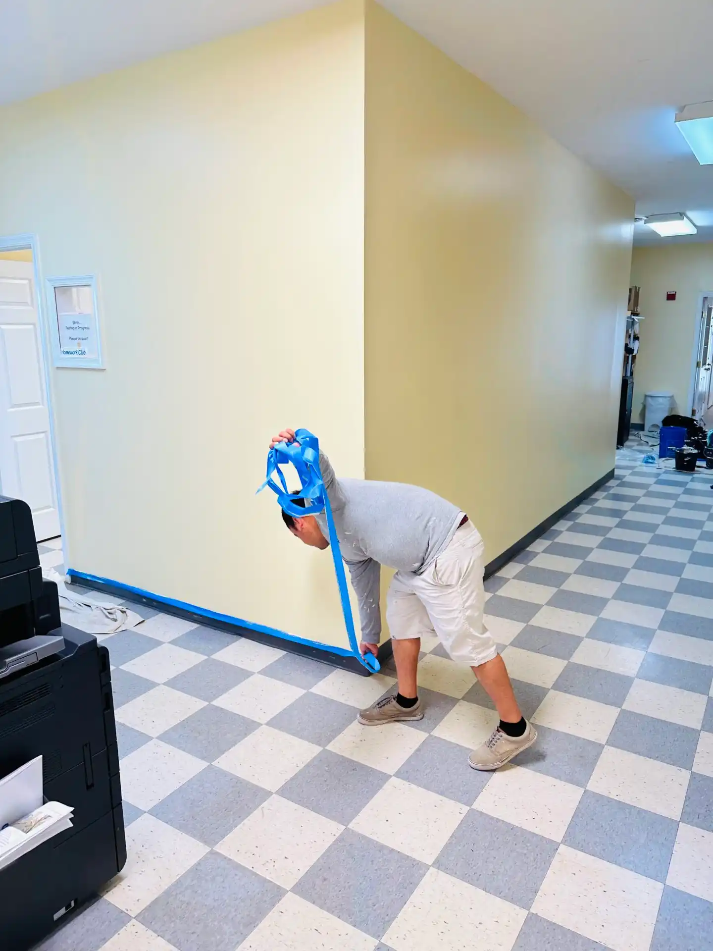 Painters working in a school hallway